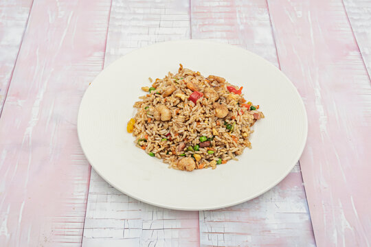 Seafood chaufa, a colorful dish with a variety of seafood such as prawns, squid, and scallops, stir-fried with rice, egg, bell peppers, and scallions