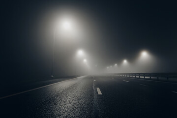 Foggy misty empty road at night