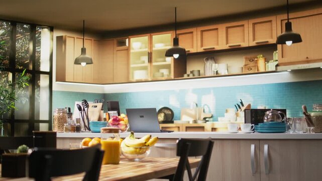 Empty kitchen table with croissants and homemade food for breakfast, contemporary apartment. Bright space with stylish kitchenware, fresh fruits and condiments on the counter, cozy home.