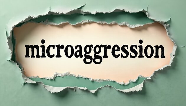 Word microaggression in bold sans serif font appears in ragged hole of green paper. Subtle peach paper behind torn edges. Focus on subtle discrimination and bias.