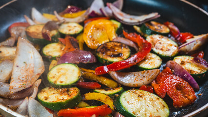 Colorful mix of cucumbers, red onions, mushrooms, and bell peppers sizzling in a pan, releasing steam. Sautéed to perfection—succulent, healthy, and full of natural flavor. Perfect side or main dish.