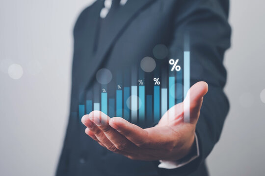 Hand holding graph with percentage, special offer of shopping department store discount and tax concept, adjusting interest rates, raising interest rates to fight inflation, returns on investments.