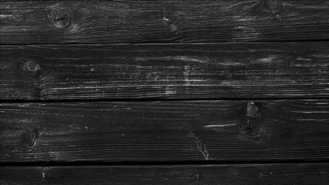 A close-up of a worn and textured wooden plank.