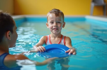 Young boy with Down syndrome smiles in pool holding blue float. Child practices swimming lesson with instructor. Kid learns water safety skills.