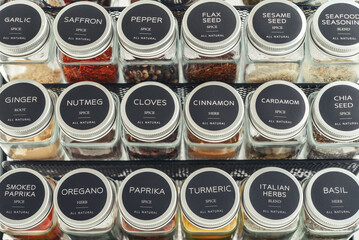 Assorted spices in glass jars with metal lids
