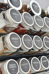Assorted spices in glass jars with metal lids