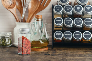 Assorted spices in glass jars with metal lids