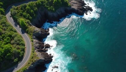 Aerial view of winding asphalt road along green forested cliff next to blue ocean waves. Nobody on scenic coastal drive path. Pure nature landscape with turquoise water. Travel destination.