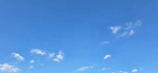 Beautiful blue sky with fluffy white clouds and copy space for background