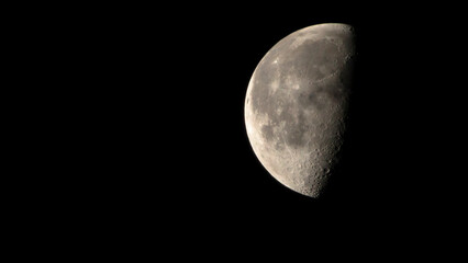Half moon in the dark night. Close-up of half moon.
