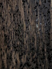 Raindrops scattered on wooden surface