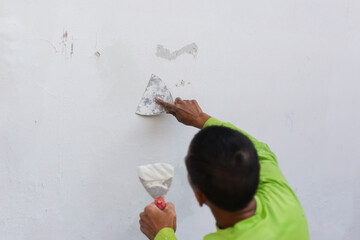 Painter's hand puttied wall using a paint trowel.