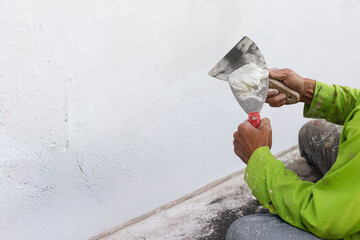 Painter's hand puttied wall using A paint trowel.