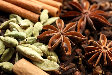 Mulled wine spices. Anise stars, cinnamon sticks, cardamon seeds and cloves as background, closeup