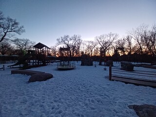 Obraz premium Orange playground structure covered with snow