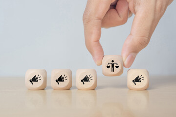 Ethical marketing and communication concept. Using responsible communication and practices that respect the interests of stakeholders. Wooden cube blocks with ethics and marketing communication icons