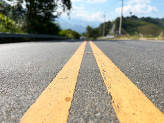 Yellow traffic line color Double solid lines to warn prohibiting overtaking, Yellow continuous tracks of prohibited overtaking painted on the asphalt, Safety driving and traffic regulating rules