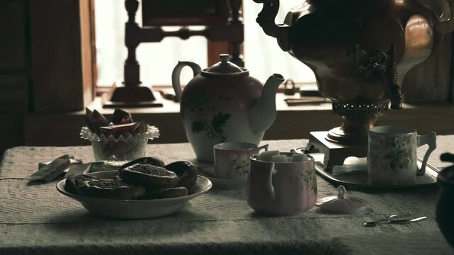 A traditional Russian table setting with baranki, a samovar, teapot, and mugs, showcasing classic Russian culture and folk hospitality.