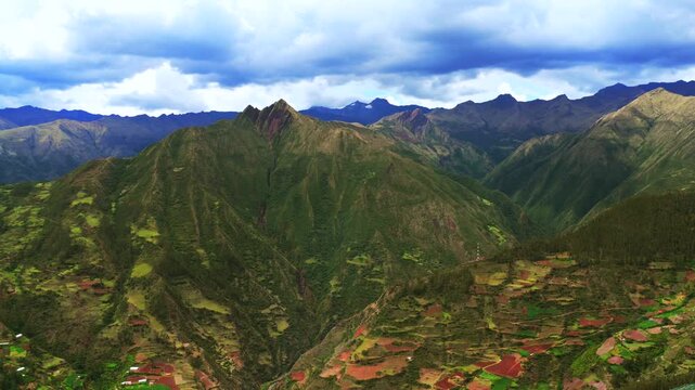 Limatambo Peru aerial drone highlands avocado farm crops Peruvian Andes mountain range Cusco region Heertahuayco warm climate Soray rainy season clouds mount Humantay Salkantay valley forward motion