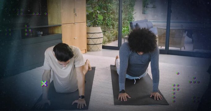 Two men pressing up from prone and flowing yoga on black mats for flexibility training