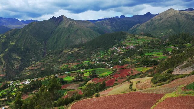 Peruvian Andes mountain range Limatambo Heertahuayco valley highlands avocado farm crops mount Humantay Salkantay Peru aerial drone Cusco region warm climate Soray rainy season clouds forward pan up