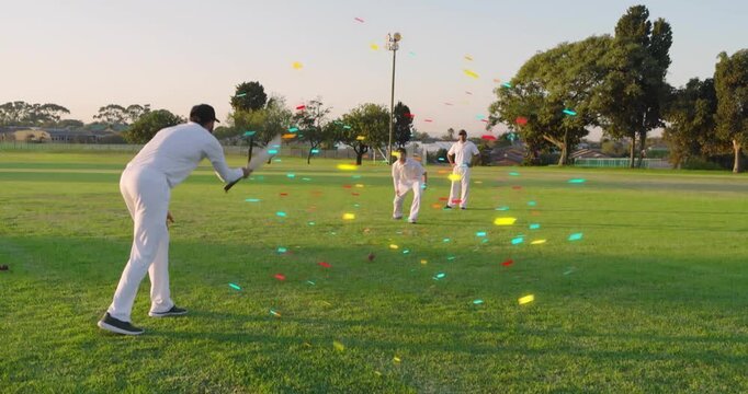 Bowler releasing, causing confetti streaking, batsman swinging bat, fielder gathering ball, cricket