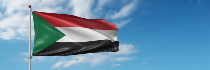 Proud Sudan flag waving beautifully against a clear blue sky, embodying freedom and national identity
