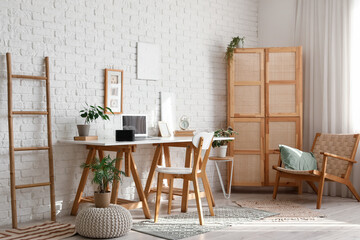 Interior of office with workplace and aroma diffuser