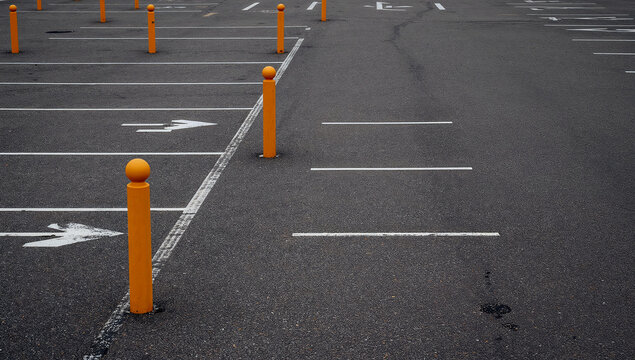 Quiet parking lot with yellow bollards showcasing order and structure