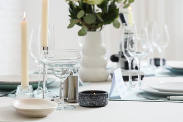 Elegant table setting for Nobel prize day with microscope and candles in dining room