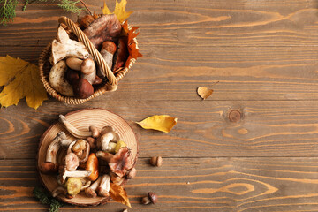 Wicker basket and stand with fresh mushrooms on wooden background