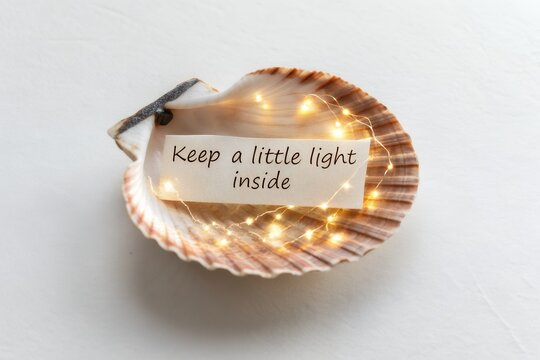 Seashell holding a paper message with string lights inside - Powered by Adobe