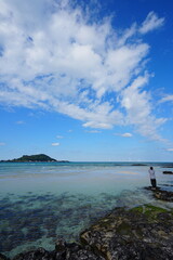 clear shoaling beach and far island