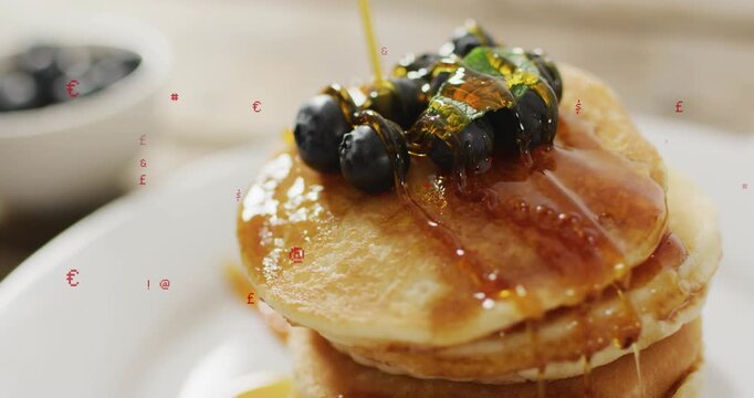 Golden syrup pouring from top-right, coating pancake stack and blueberries to create glossy glaze