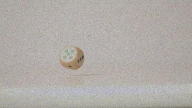 Wooden die launched by initial toss, tumbling and rotating downward, showing pip faces for study
