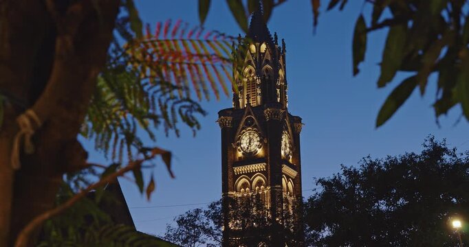 Rajabai Clock Tower In Evening Illumination. Clock Tower In Mumbai India. Confines Of Fort Campus Of University Of Mumbai. Modeled It On Big Ben In London. It Stands At Height Of 85 M Or 280 Ft