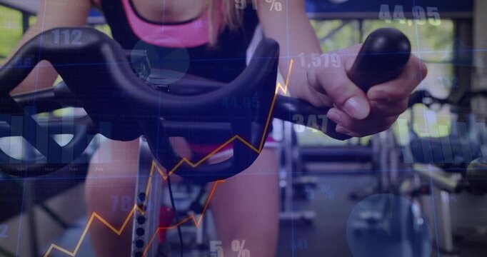 Woman mounting and riding spin bike at gym, pushing harder, animated charts tracking performance
