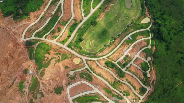 A top-view aerial of Tandatangan Signature Golf Course with winding fairways and forest edges in Mariveles, Bataan, Philippines