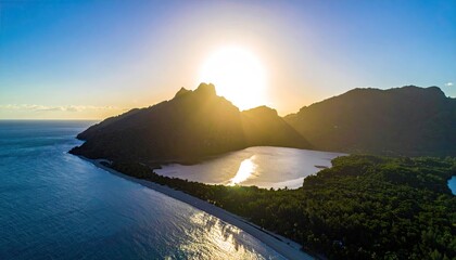 Sunrise Over Lush Tropical Island With Calm Ocean And Mountain Peaks Bathed In Golden Light