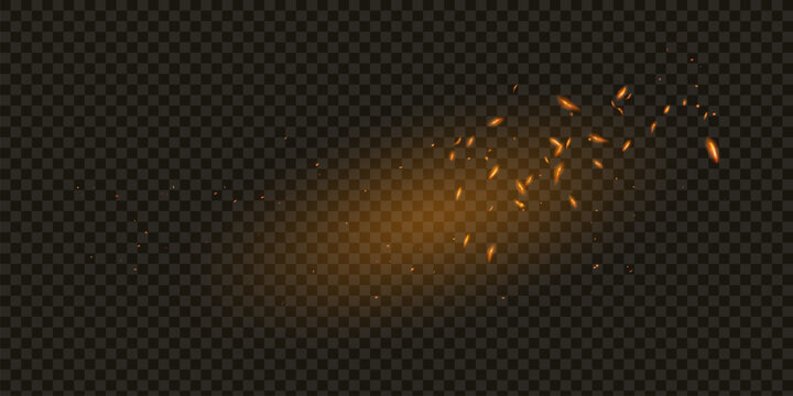 Flame of fire with sparks on a black background. The texture of the fiery storm. The fiery sparks of lights flash, a shot of a flying spark in the air. a dark night