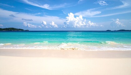 Turquoise Ocean Waves Gently Washing Ashore on a Pristine White Sand Beach Under a Vast Blue Sky with Fluffy Clouds