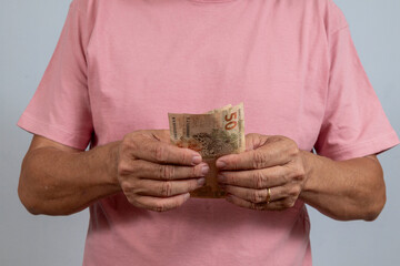 person holding a 50 real note without showing their face