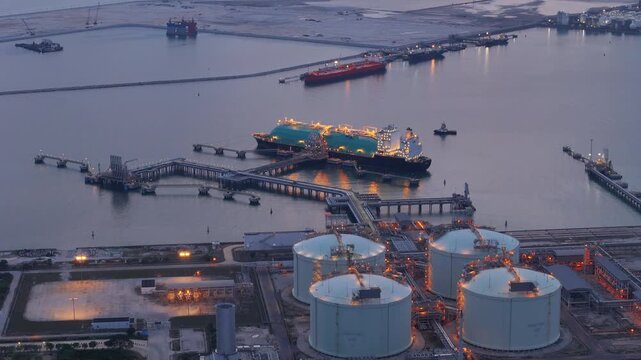 LNG (Liquified Natural Gas) tanker anchored in Gas terminal gas tanks for storage. Oil Crude Gas Tanker Ship. LPG at Tanker Bay Petroleum Chemical or Methane freighter export import transportation