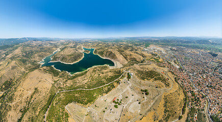 Bergama, Turkey. Pergamon Acropolis with Altar of Zeus, Trajaneum, Hellenistic theater and ancient ruins on hill, modern Bergama town and Kestel Dam below. Aerial view.