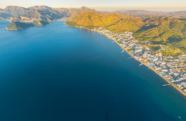 Marmaris, Turkey. Panoramic aerial view of green mountains, coastline and bay in morning sunlight. Coastal landscape with forested slopes. Aerial view.