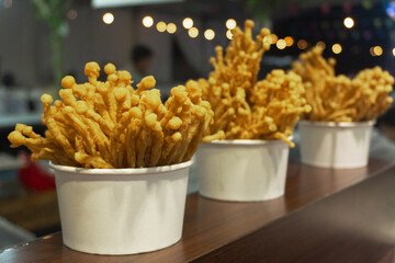 Deep fried enoki mushroom or golden needle mushroom. Sell in central of street food market.