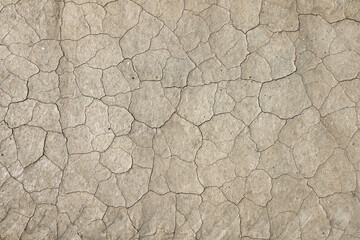 Close up view of mud flat with narrow cracks for environmental background use.