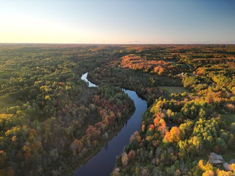 High aerial view of Muskoka River in Bracebridge Ontario Canada in fall at sunset
