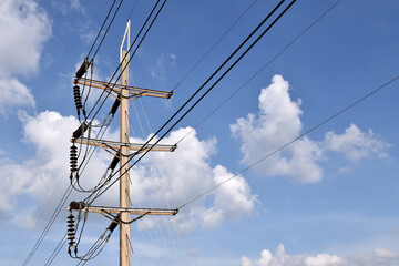 high voltage power lines connected to electrical insulators on steel beam