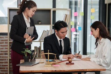 Group of male and female lawyers are giving legal advice in an office.